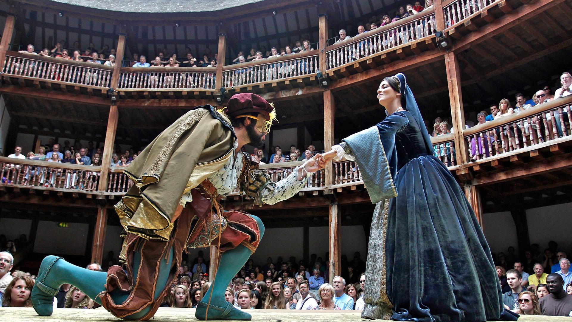 Actors Dominic Rowan (L) and Miranda Raison perform as Henry VIII and Anne Boleyn in Shakespeare's "Henry VIII" at Shakespeare's Globe in London.