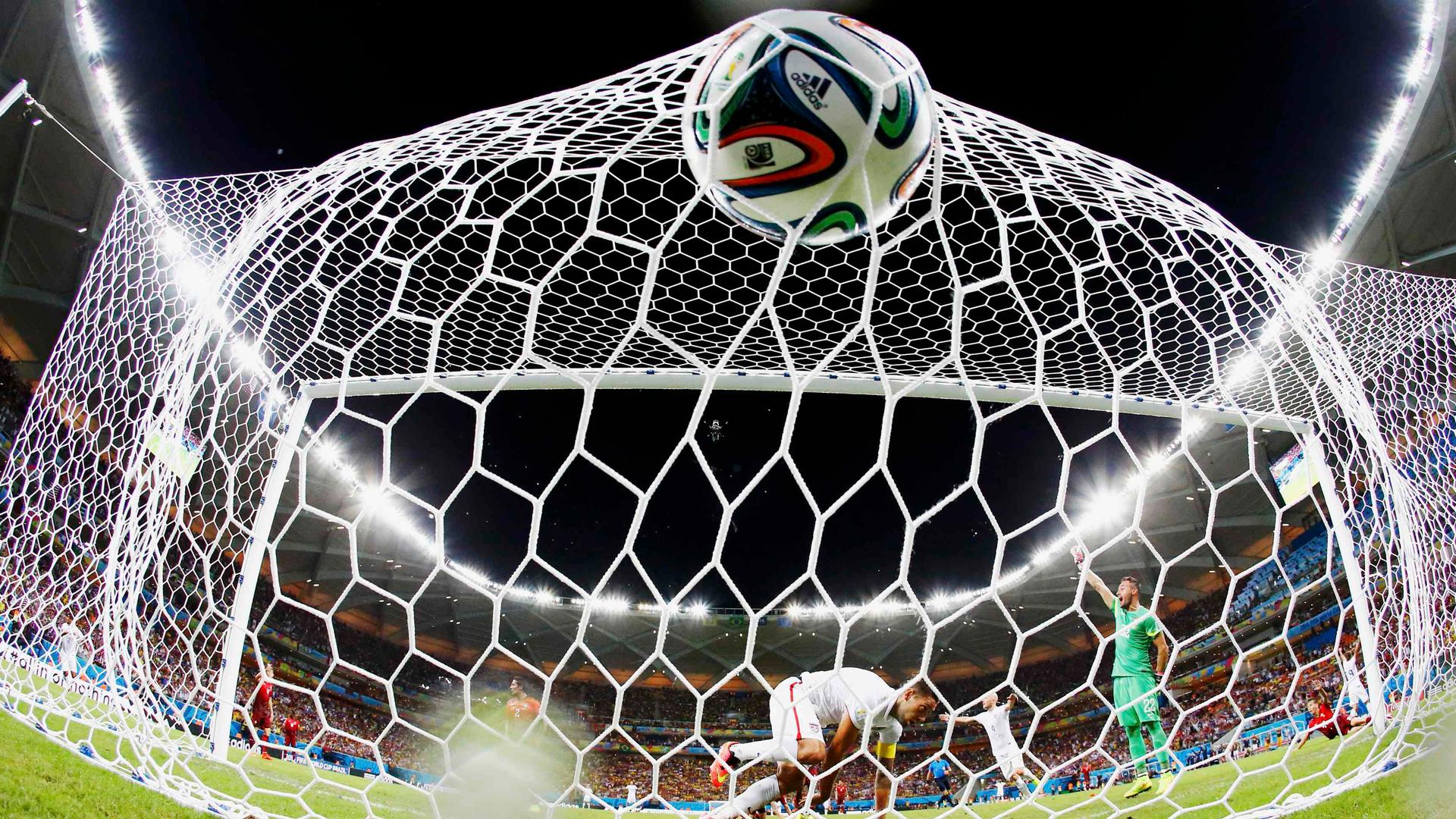 Clint Dempsey (C) of the U.S. knocks the ball into the net to score against Portugal during their 2014 World Cup Group G soccer match at the Amazonia arena in Manaus