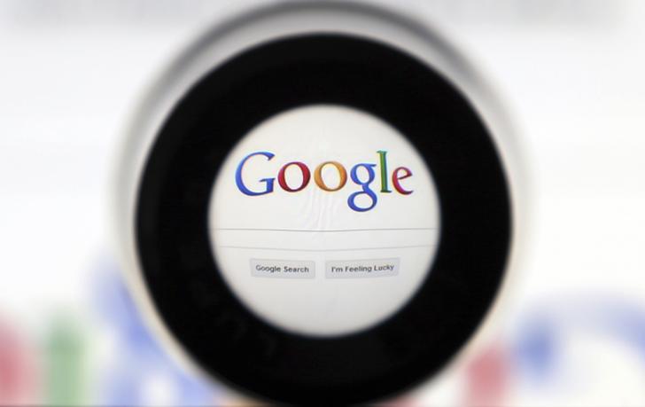 A magnifying glass centers in on the Google logo.