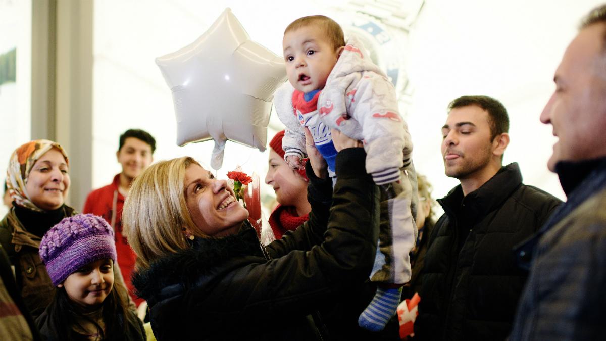 Tima Kurdi (middle), holds up her nephew Sherwan Kurdi as she welcomes her brother Mohammed Kurdi (R), and his family at Vancouver International airport in Vancouver, British Columbia, December 28, 2015.  