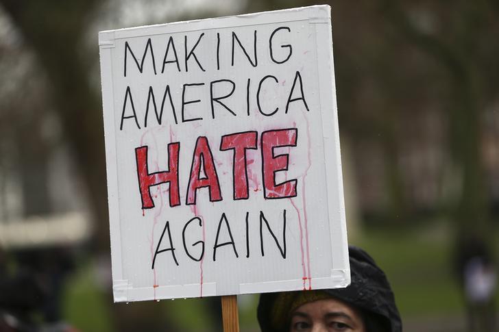 A protestor carries a sign that reads "Making America Hate Again."
