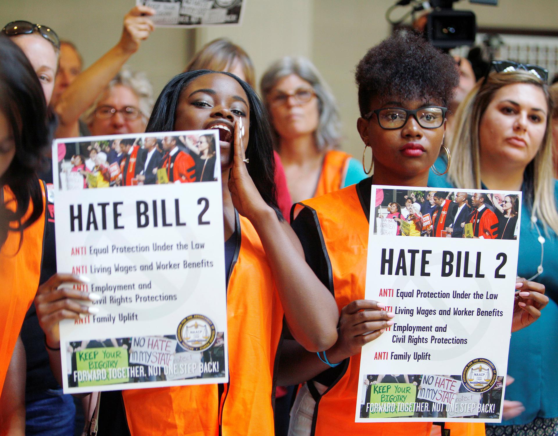 Members of the black community shout out their opposition to North Carolina's HB2
