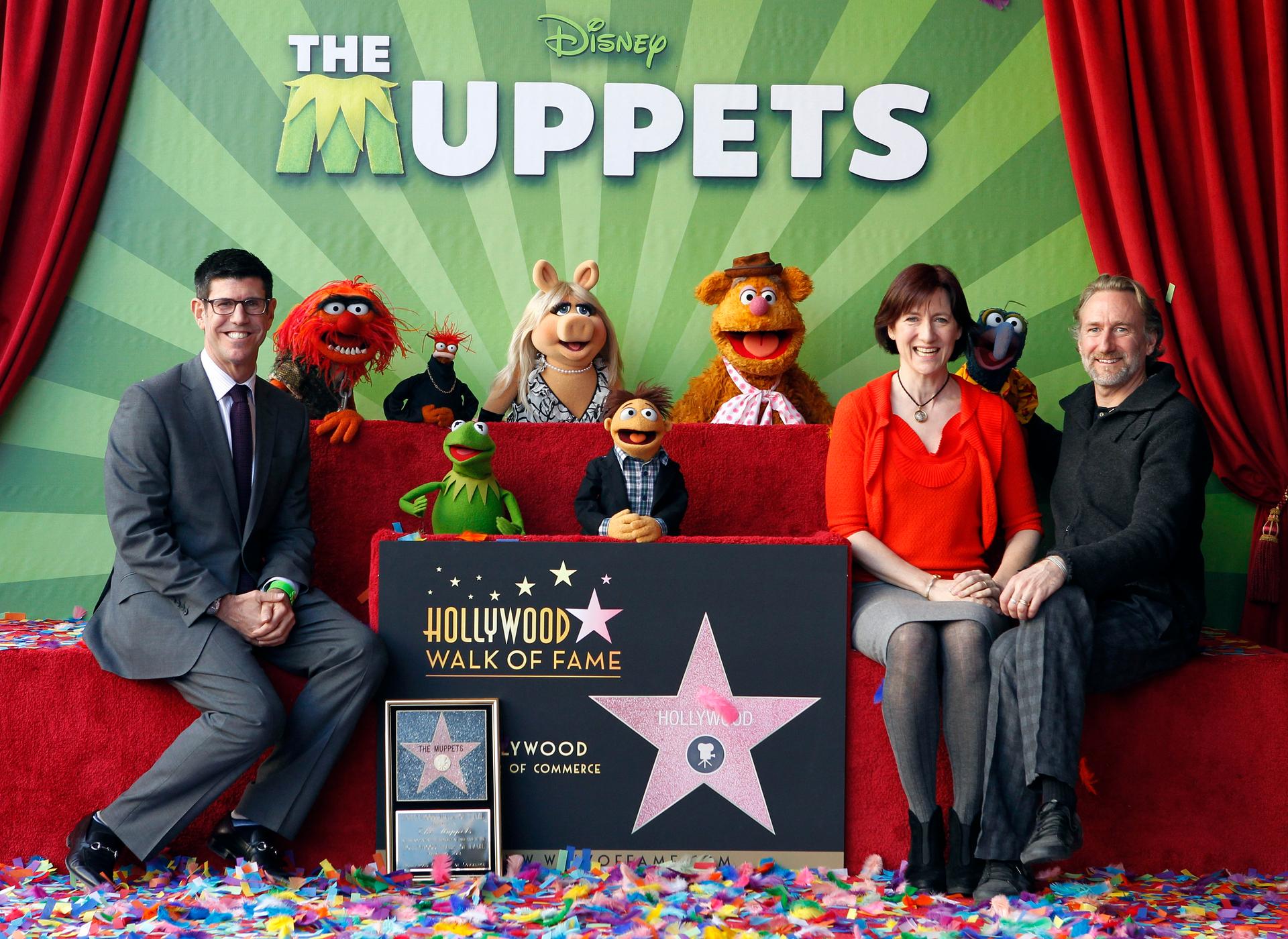 Rich Ross, Lisa Henson, CEO of The Jim Henson Company, and her brother Brian Henson and the muppets