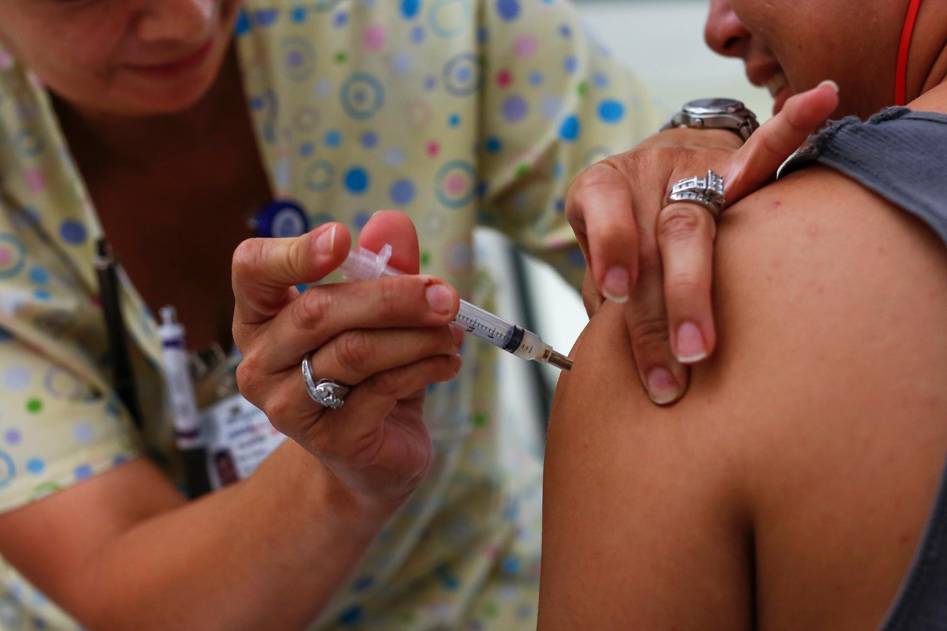Teenager receives an immunization