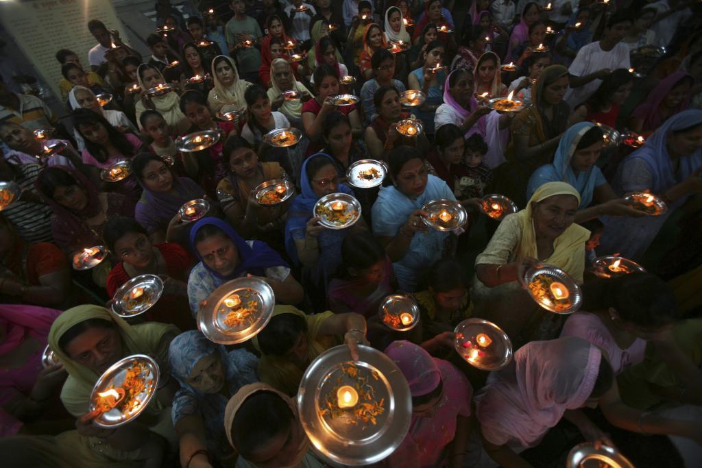 Hindu devotees pray inside a temple in the northern Indian city of Chandigarh, Oct. 8, 2010.