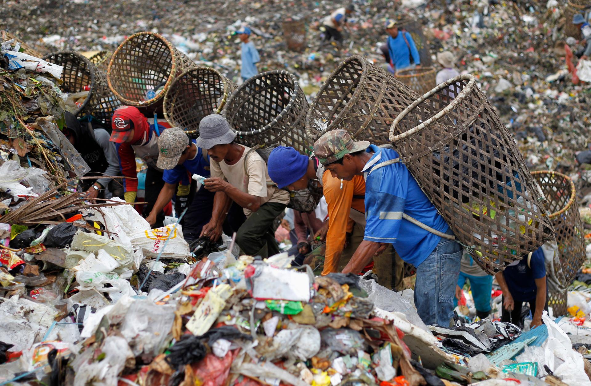 Scavengers search for items to recycle at a waste dump in Bogor, a city in Indonesia's West Java province, on June 3, 2013.