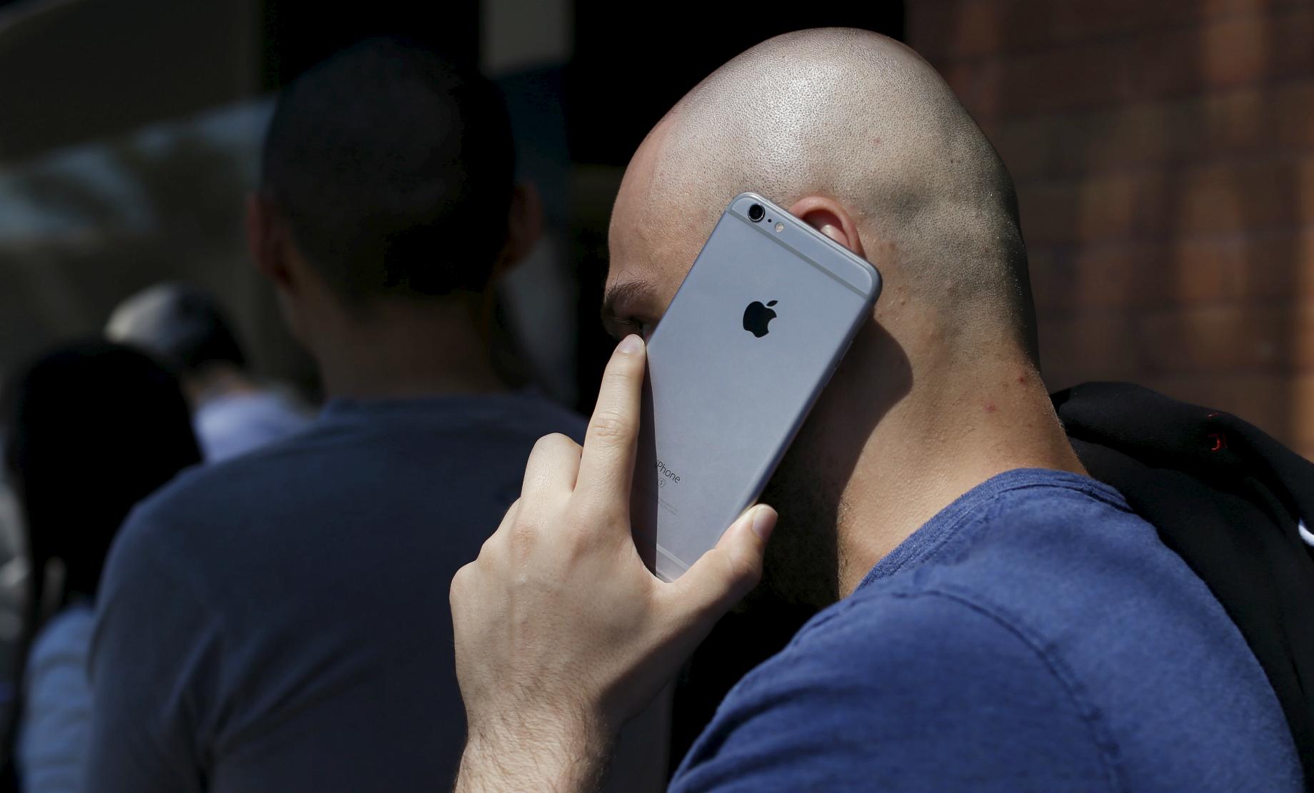 A person talks on his Apple iPhone in Pasadena, California, on March 31, 2016. 