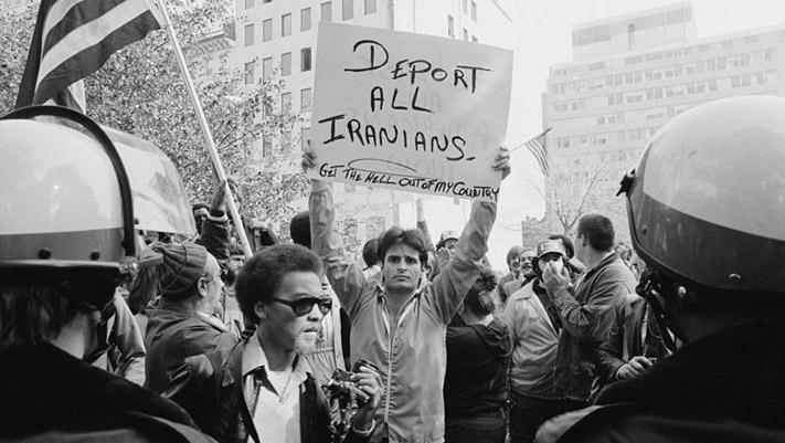 A man holding a sign during a protest of the crisis in Washington, D.C., in 1979.