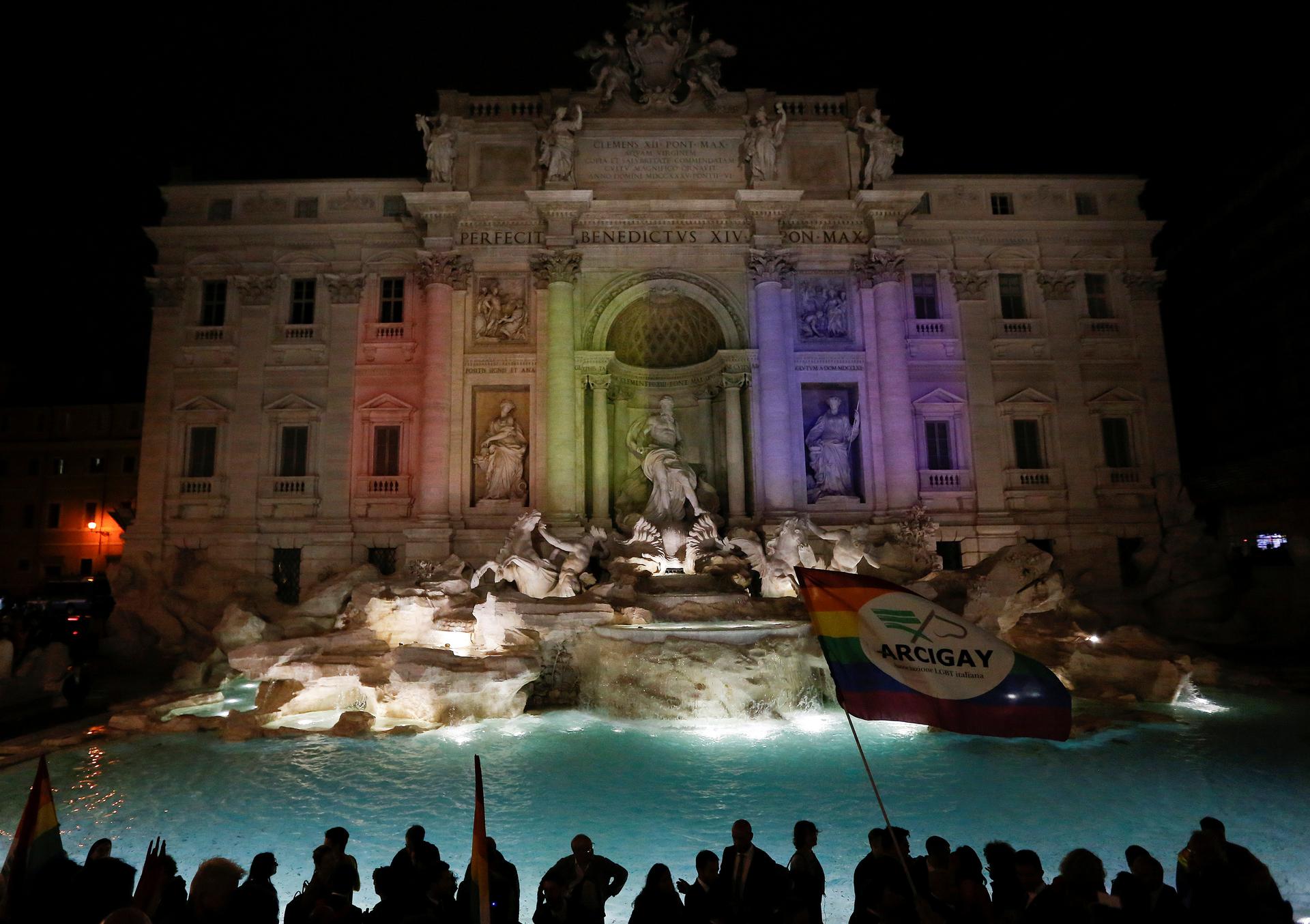 Lights are projected onto the Trevi Fountain to make it look rainbow coloured to celebrate the civil unions bill in Rome May 11, 2016.
