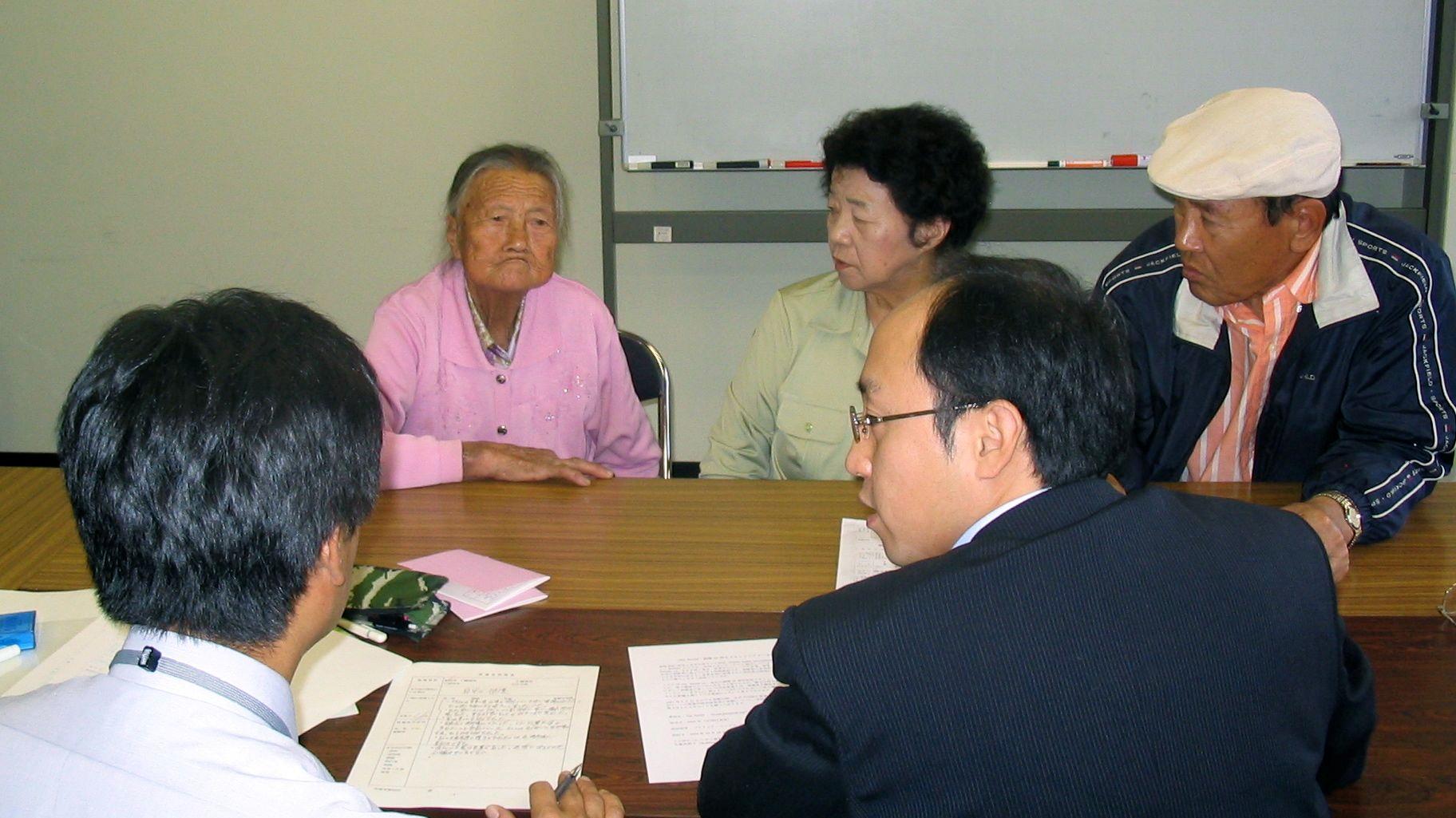 An elderly Korean woman appears with her son and daughter-in-law at a hearing in Hiroshima to determine whether she is eligible for special rights accorded to survivors of the atomic bomb.
