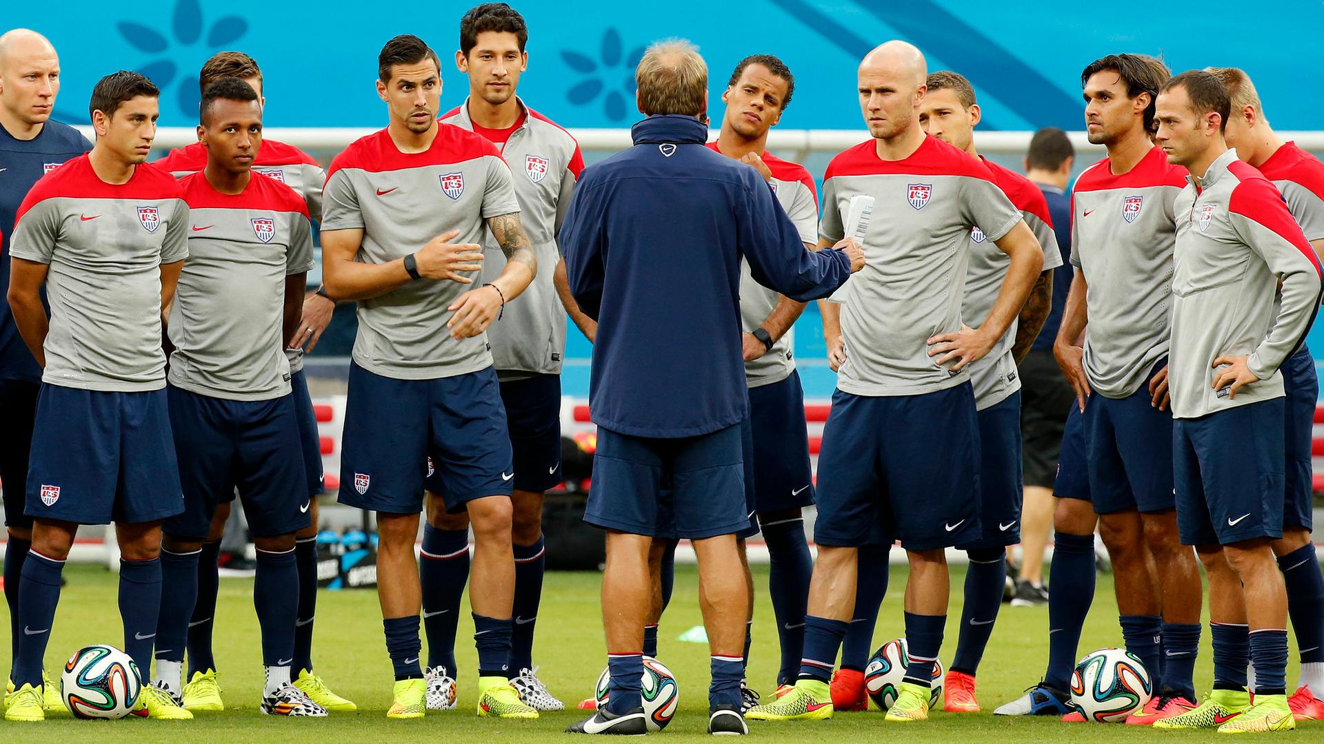 USA national soccer team head coach Jurgen Klinsmann (C) speaks to his players ahead of their training session in Manaus.