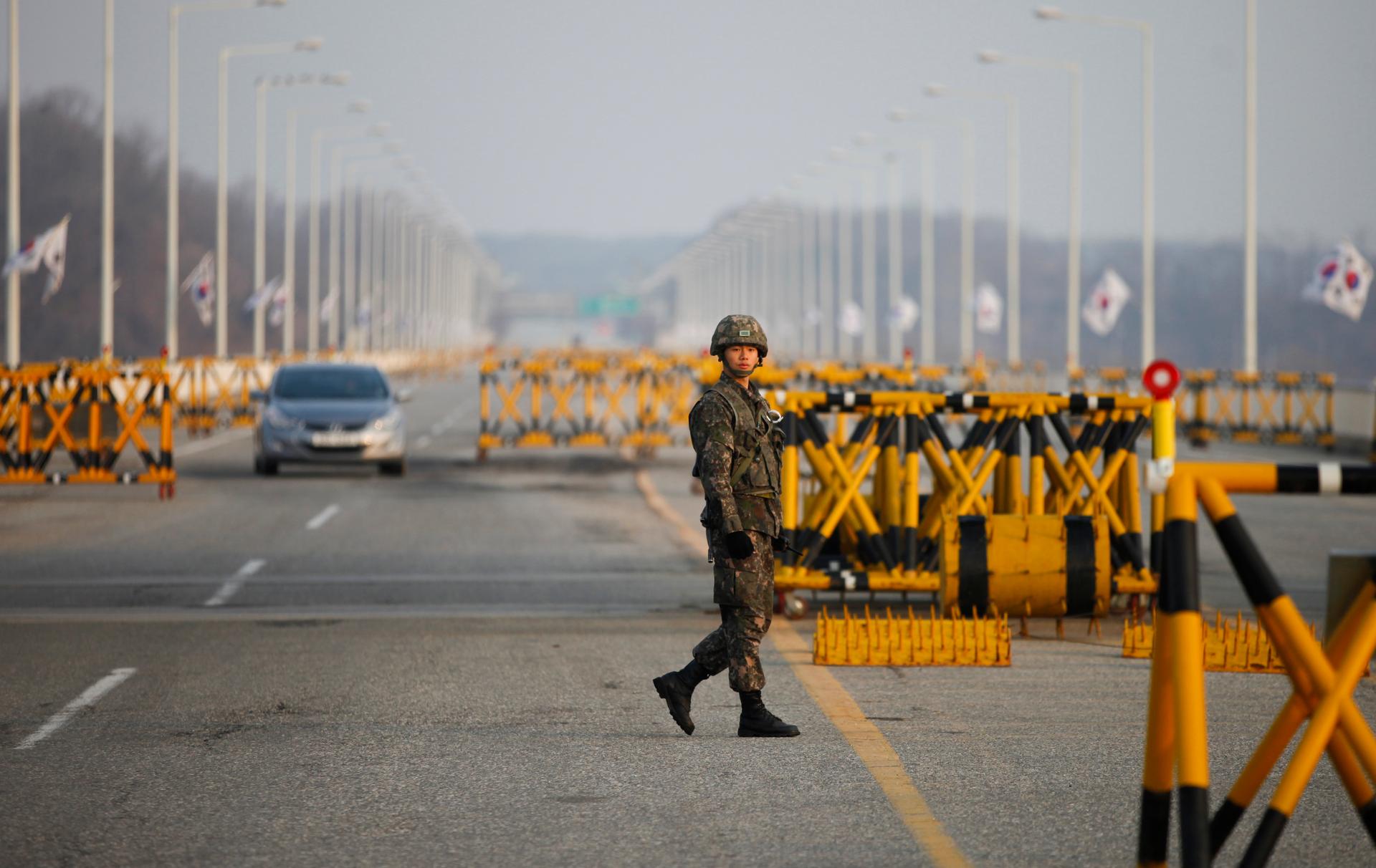 A South Korean soldier patrols at a checkpoint on the Grand Unification Bridge, which leads to the demilitarized zone separating North Korea from South Korea, in Paju, north of Seoul, April 8, 2013.