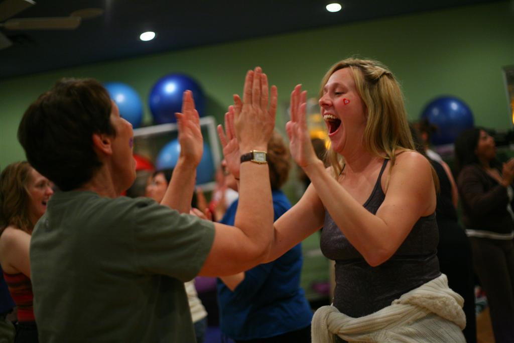 A woman laughs at a laughter Yoga class in Dallas