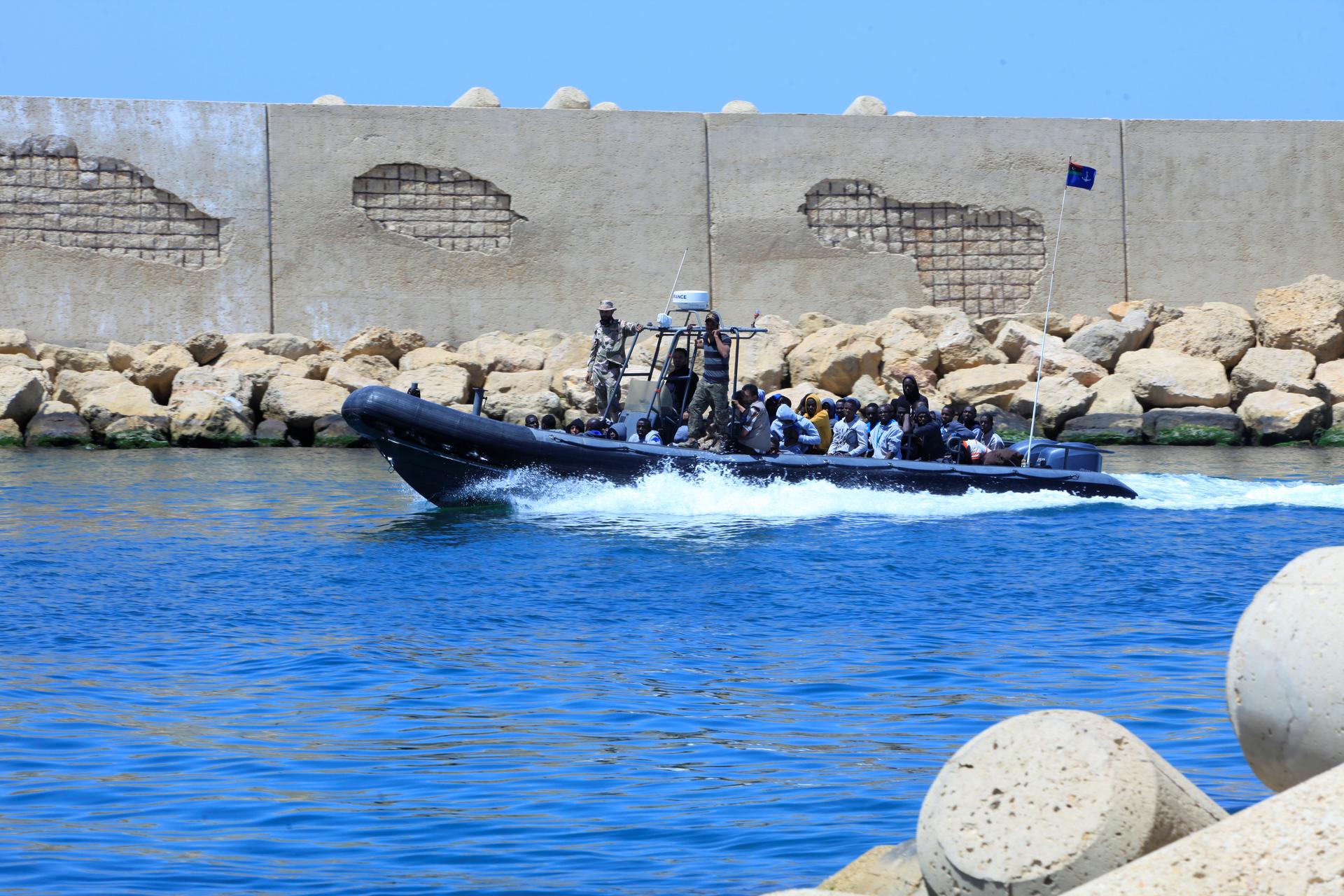 A Libyan Navy boat transports migrants who attempted to flee to Europe back to the coastal city of Tripoli