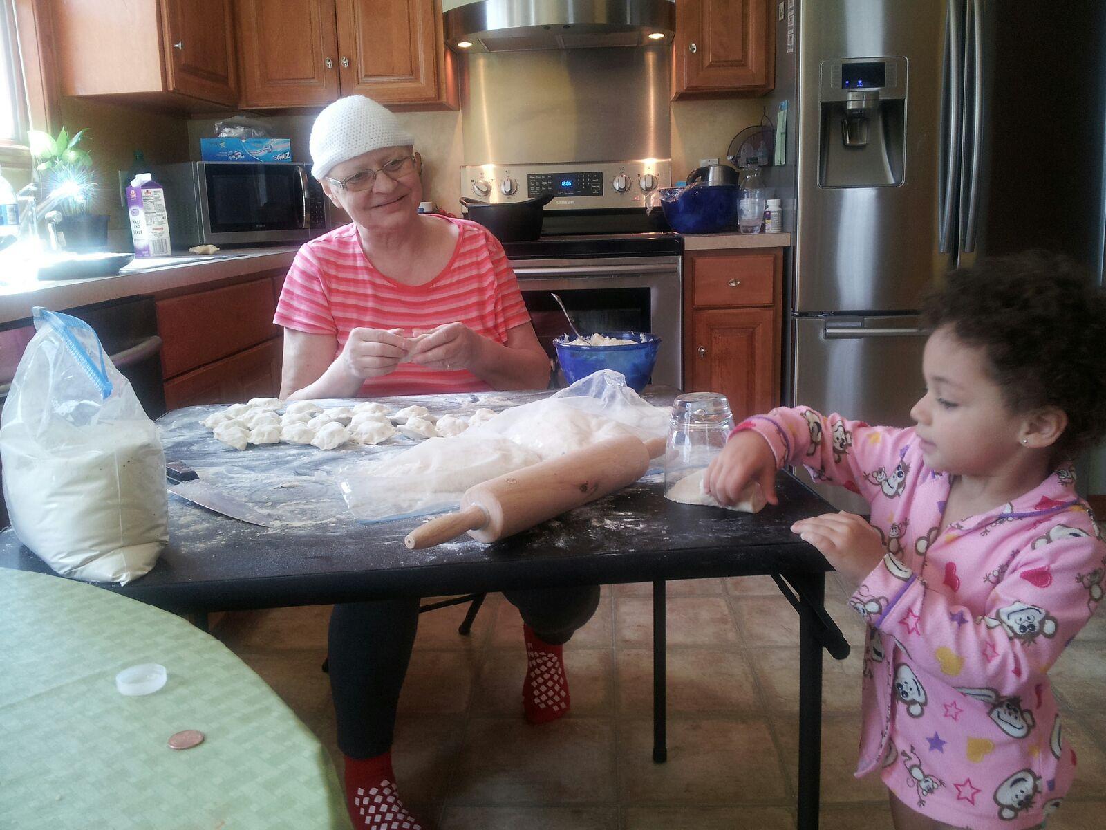 Katarzyna Ploszaj's mother, Ela, making pierogies with a young relative