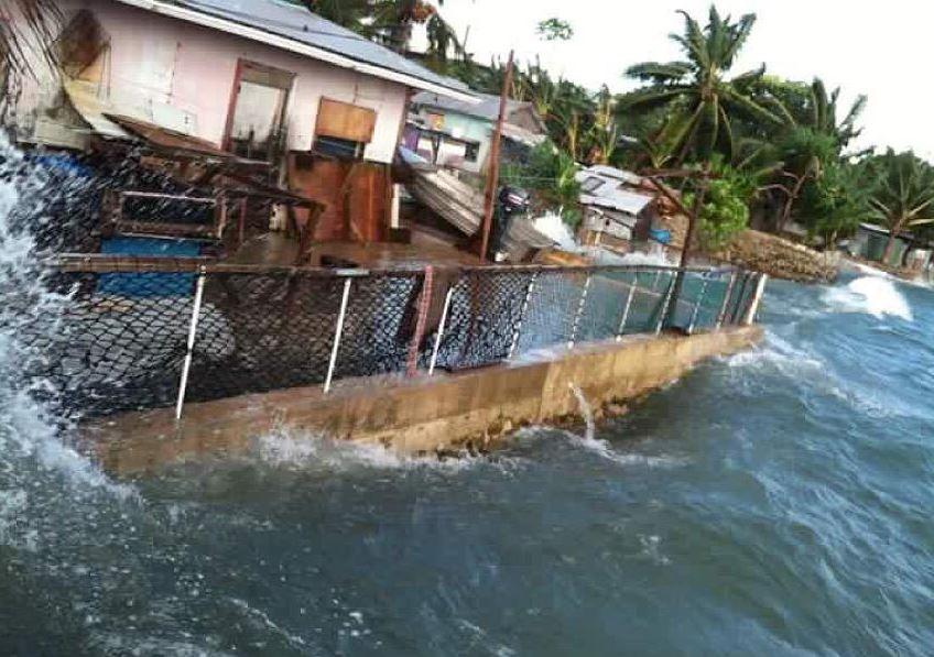 Ocean waves hit perilously close to a house in Majuro. Marshall Islands. 