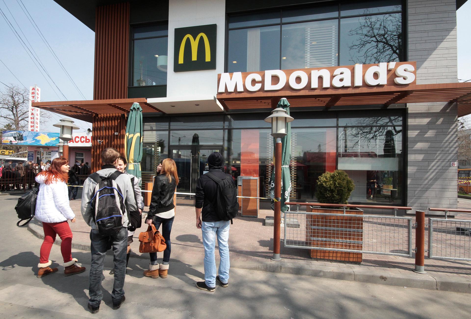 People gather outside a McDonald's restaurant, which was earlier closed for clients, in the Crimean city of Simferopol April 4, 2014. McDonald's has suspended work at its restaurants in Crimea for "manufacturing reasons", the U.S. fast food chain said on