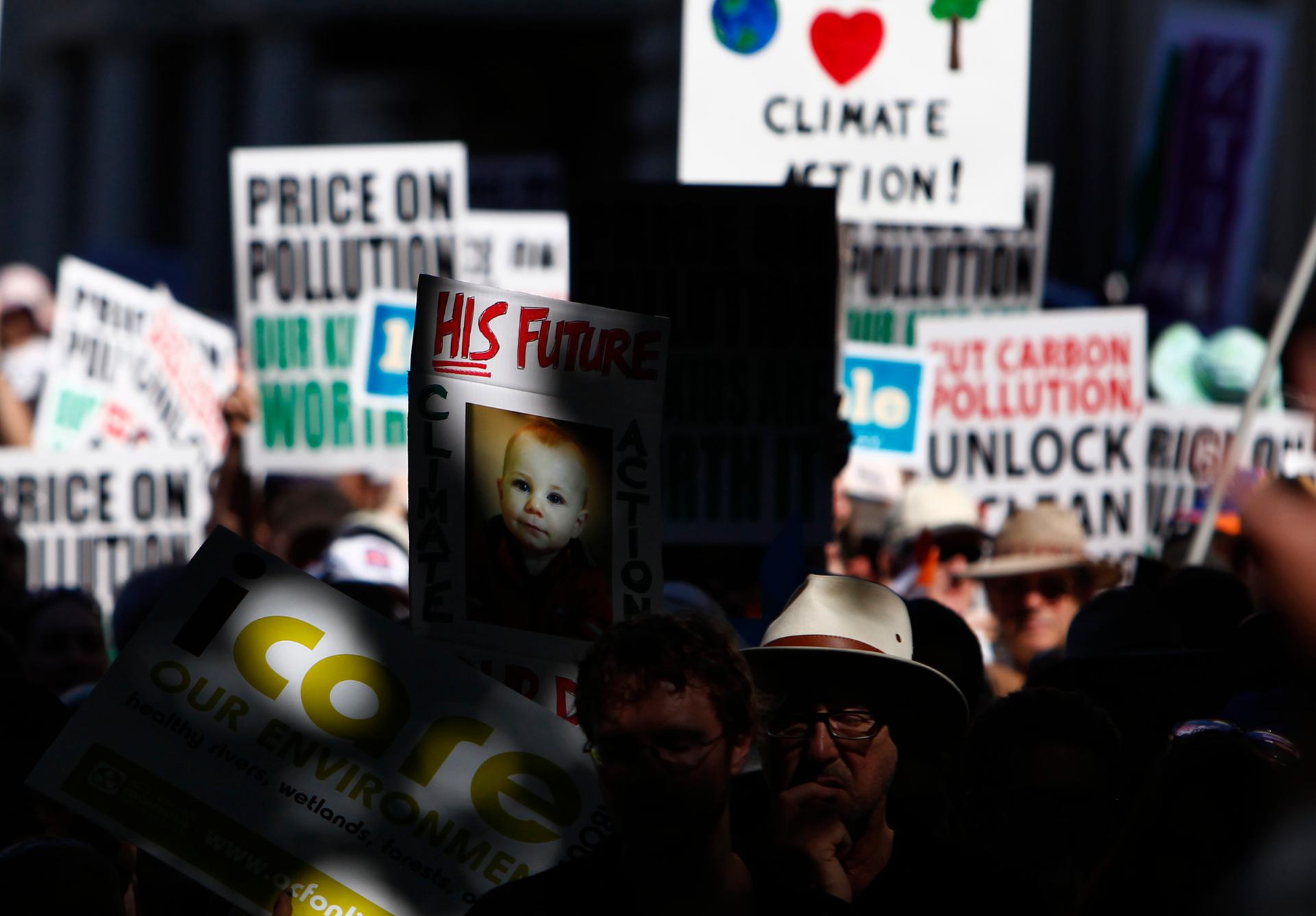 Protesters carrying placards attend a rally in favor of taxing carbon emissions in Melbourne, Australia, on March 12, 2011.