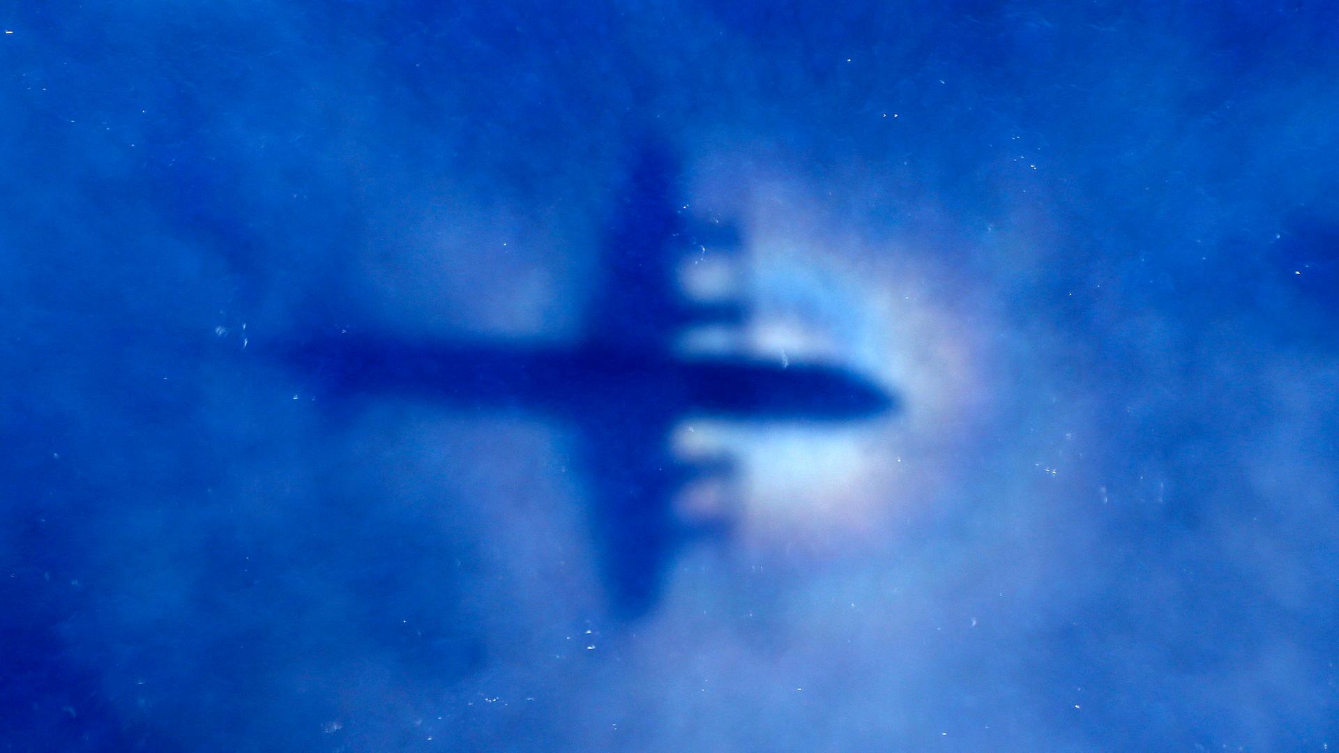 The shadow of a Royal New Zealand Air Force P-3 Orion maritime search aircraft can be seen on low-level clouds as it flies over the southern Indian Ocean looking for missing Malaysian Airlines Flight 370 on March 31, 2014.