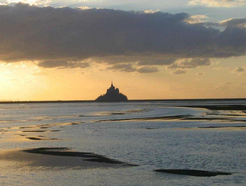 Ocean tides surround Mont Saint-Michel, the Benedictine abbey that's perched on a rocky islet.