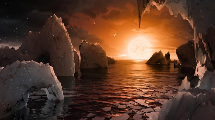 An artist's rendition of one of seven new planets discovered by NASA in February, 2017 depicts a sun setting over a watery surface dotted with sculptures that look like ice. 