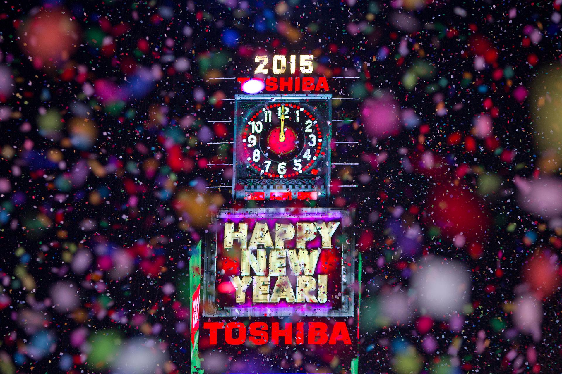 Confetti flies around the ball and countdown clock in Times Square on New Year's Eve in New York January 1, 2015.