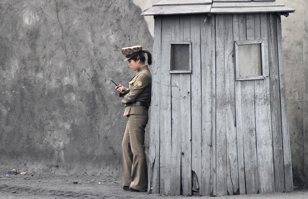 A North Korean soldier stands sentry on the banks of the Yalu River, June 1, 2014.