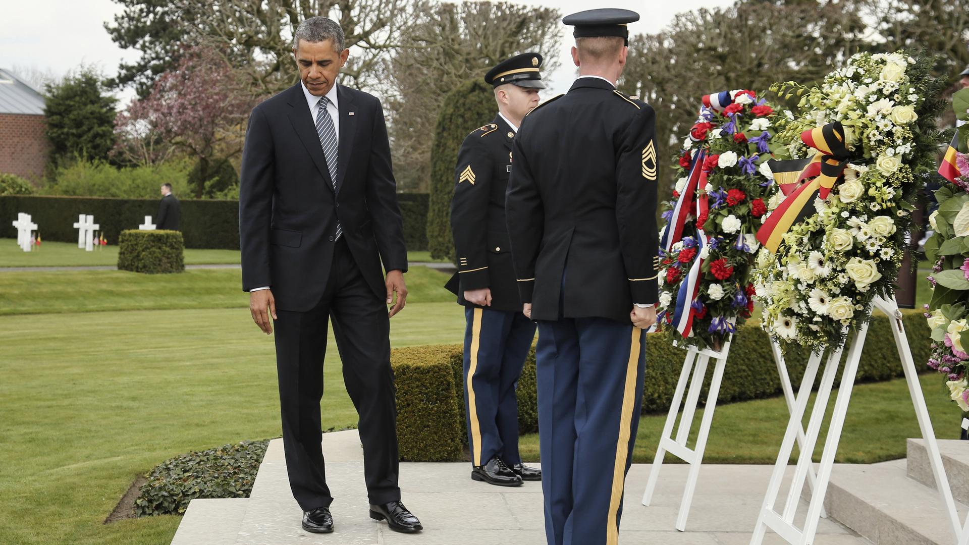 U.S. President Barack Obama attends a wreath-laying ceremony at the Flanders Field American World War I Cemetery and Memorial in Waregem March 26, 2014. Obama is on a one-day visit to Belgium where he will attend a EU-USA summit and hold a speech. 