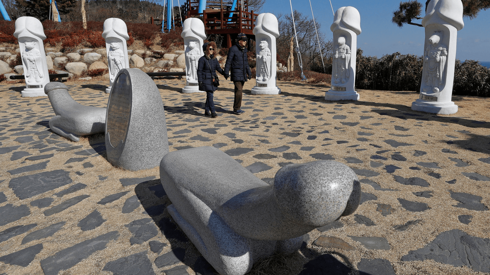 Tourists look at statues in South Korea's Haeshindang Park, also know as "Penis Park," a shrine to fertility dedicated to the legend of a local girl who died a virgin, in Sinnam, South Korea, Feb. 12, 2018.