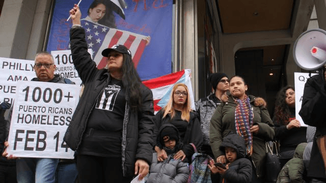 Activists call for more support for Puerto Ricans displaced by Hurricane Maria during a rally at Thomas Paine Plaza.