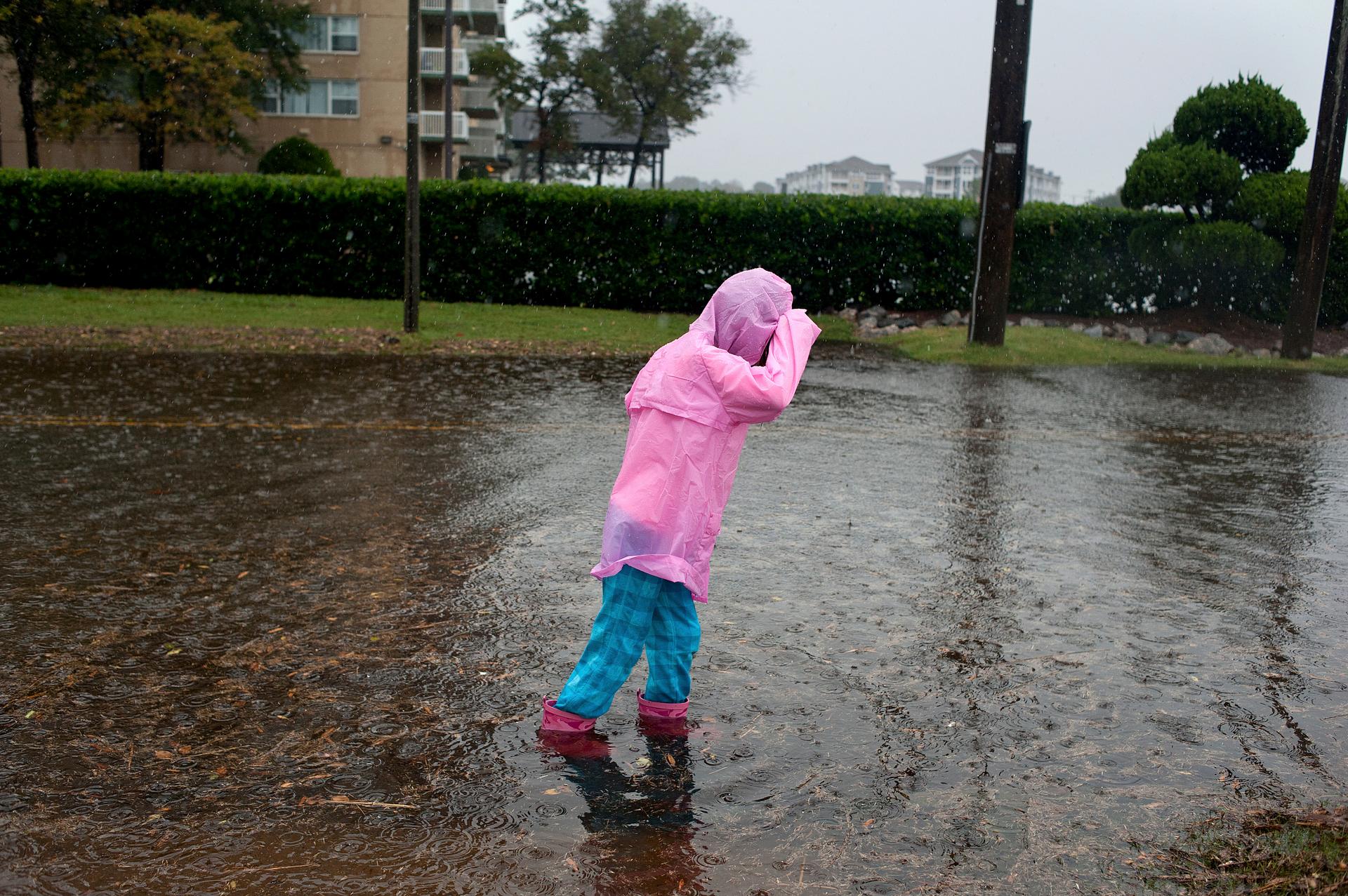 Girl walking through flooded street