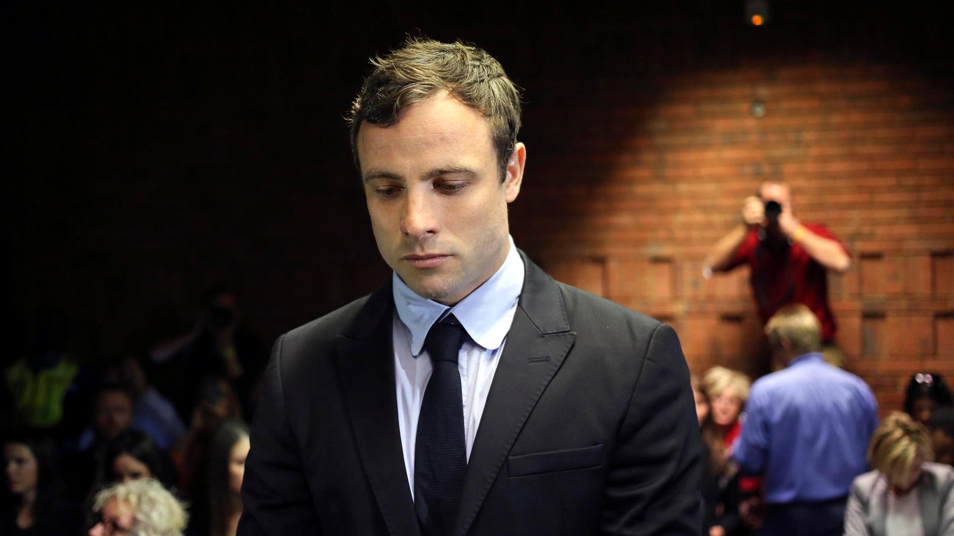 Olympic and Paralympic running star Oscar Pistorius stands during court proceedings at the Pretoria Magistrates court.