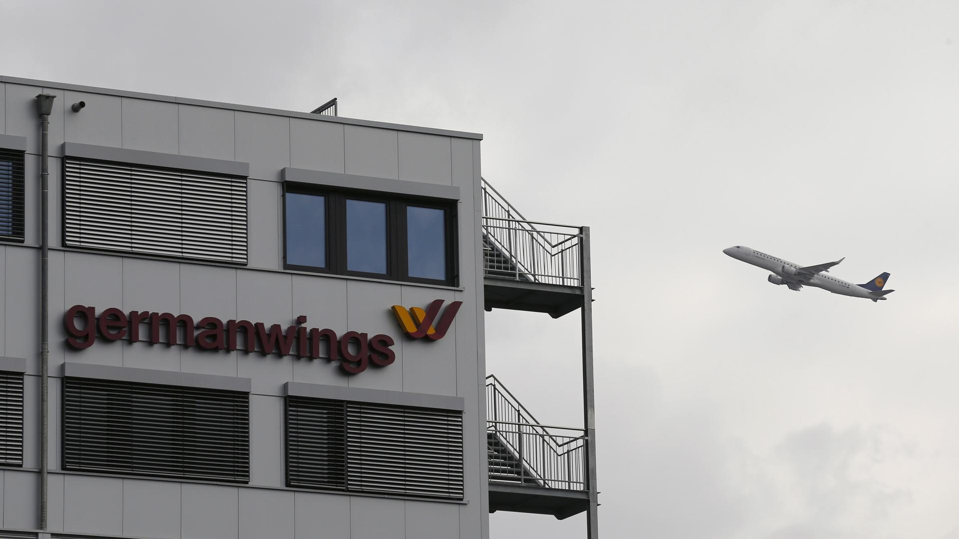 planeA Lufthansa aircraft flies past the headquarters of Germanwings during take-off from Cologne-Bonn airport.