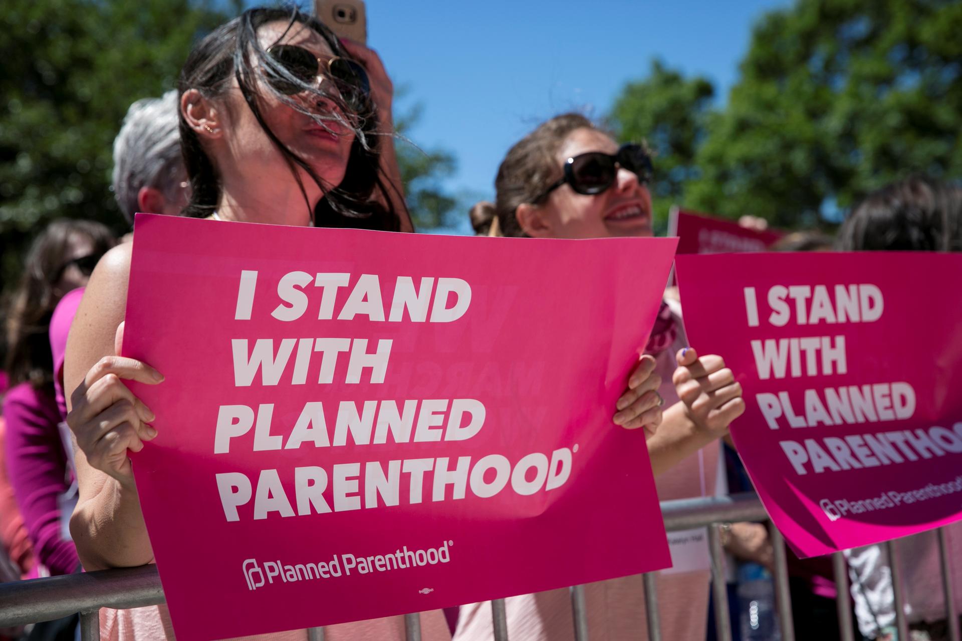 Demonstrators hold placards during a Planned Parenthood rally outside the State Capitol in Austin, Texas, April 5, 2017.
