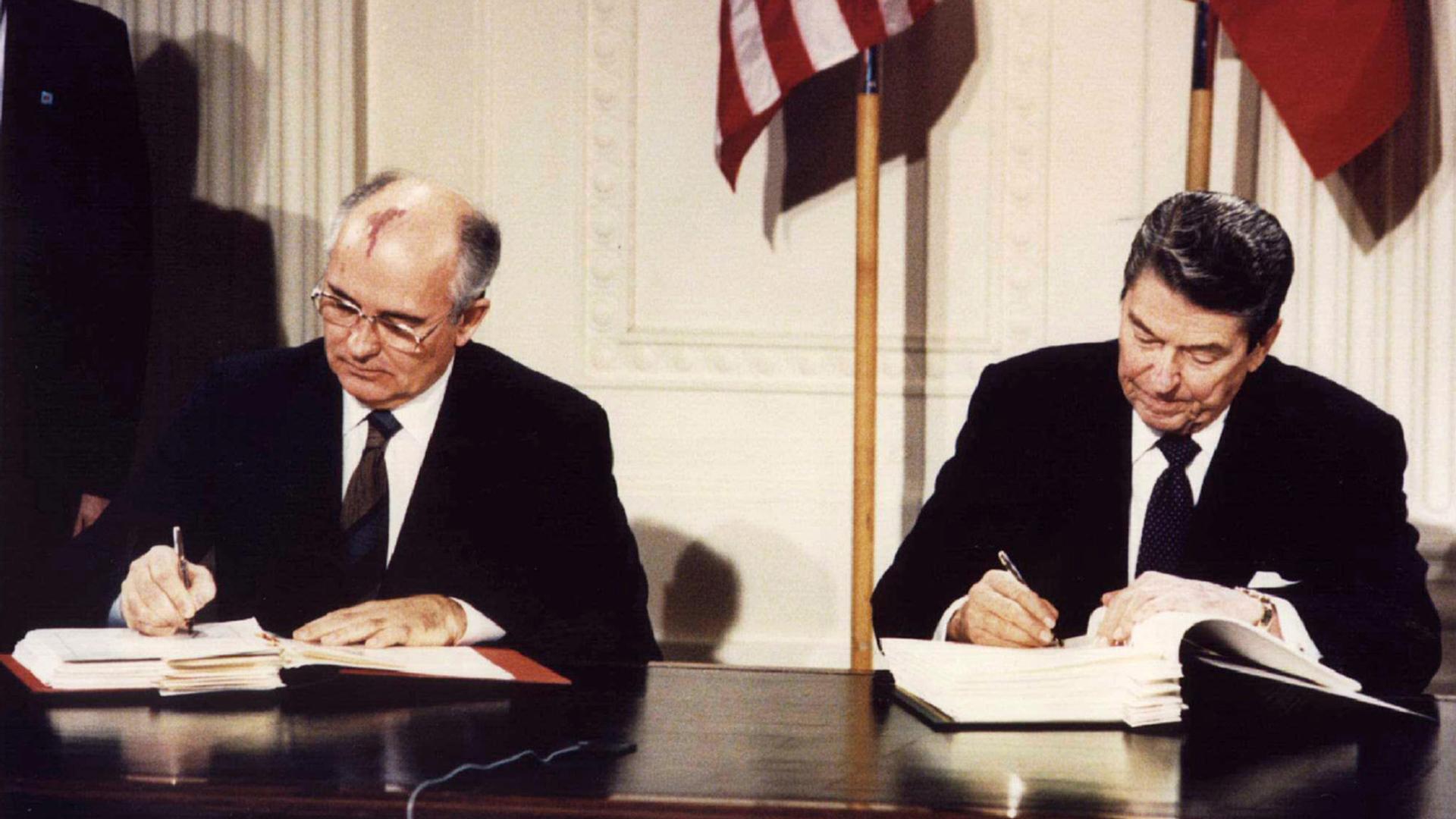 US President Ronald Reagan and Soviet President Mikhail Gorbachev signing the Intermediate-Range Nuclear Forces (INF) treaty at the White House, on December 8 1987.
