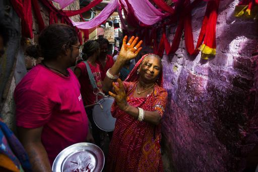 An Indian resident dances down an alleyway in front of drummers during a wedding procession in Kathputli Colony in New Delhi on June 7, 2013.