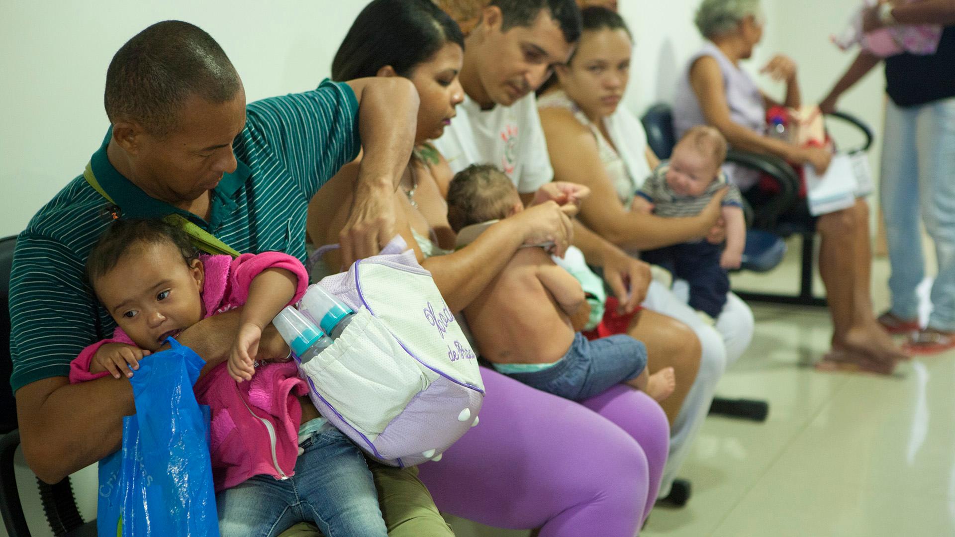 Parents wait with their children at the public hospital in Ipojuca, Brazil.