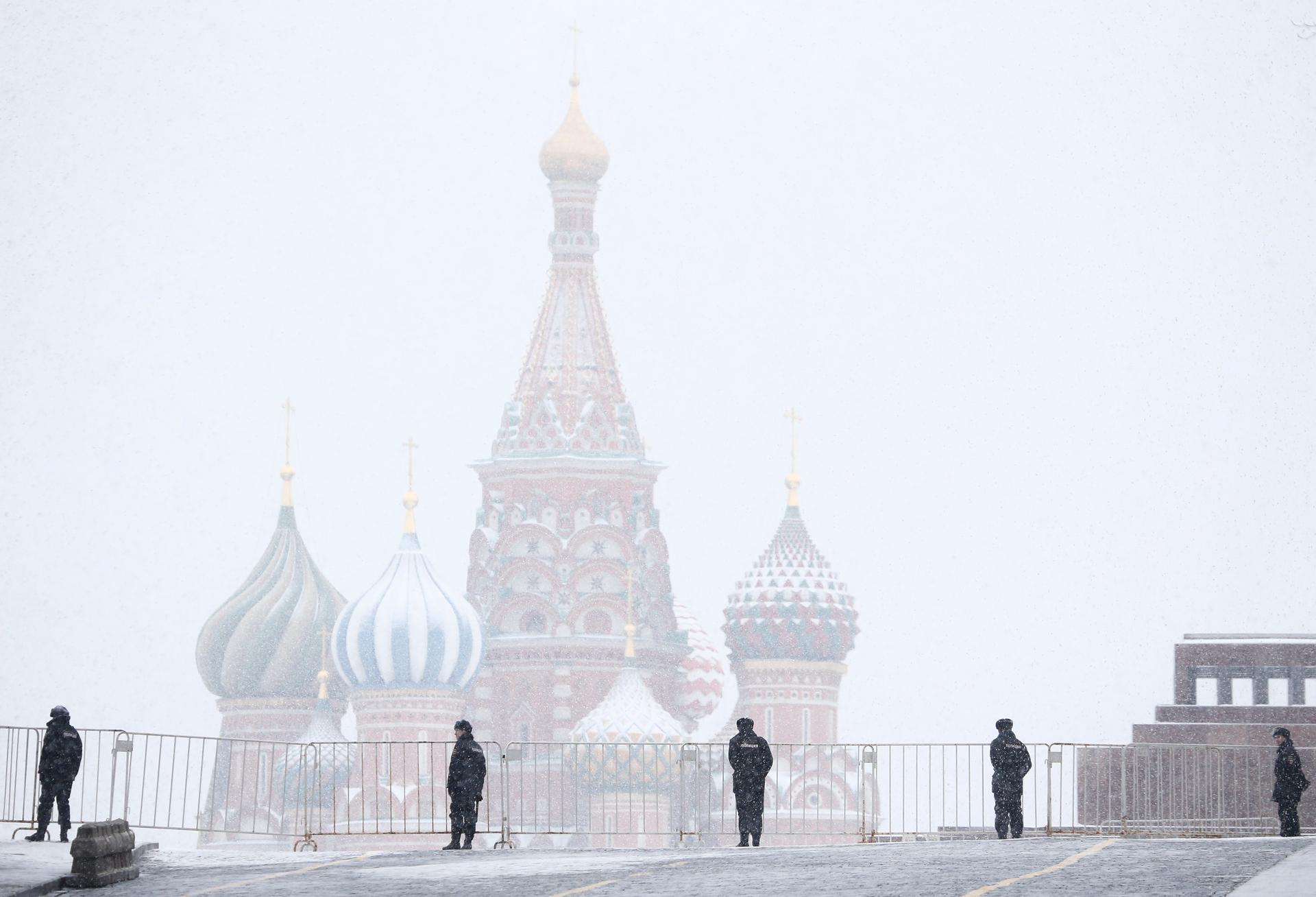 Police block access to the Red Square during a snowfall