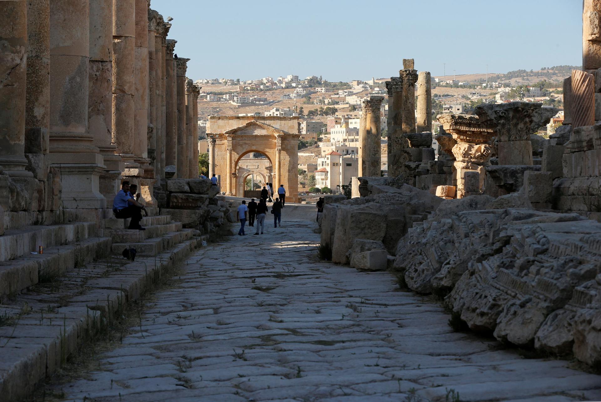 People walk along the ruins of the ancient Roman city of Jerash