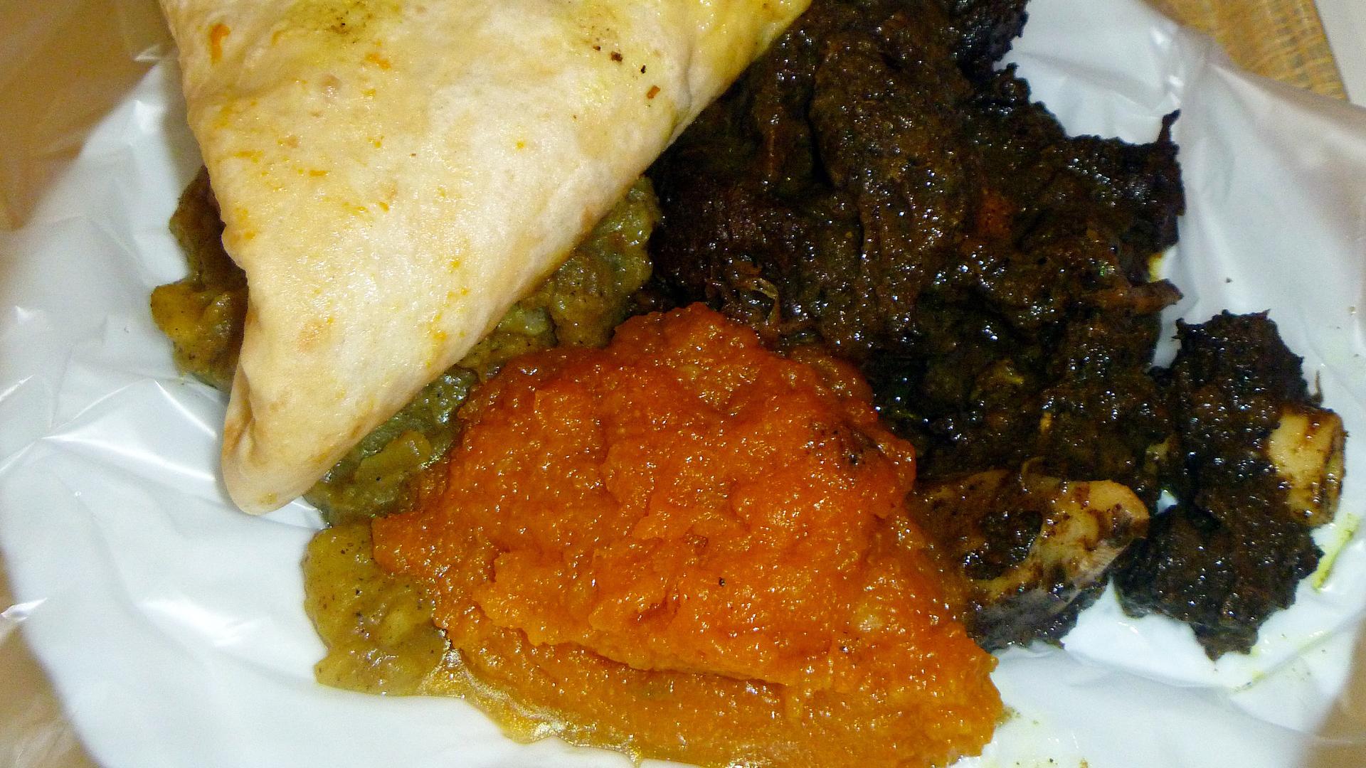 Dhalpurie roti served with pumpkin, potato and goat meat curry.