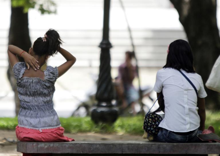Cambodian sex workers wait for customers at a public park in Phnom Penh on July 20, 2010.