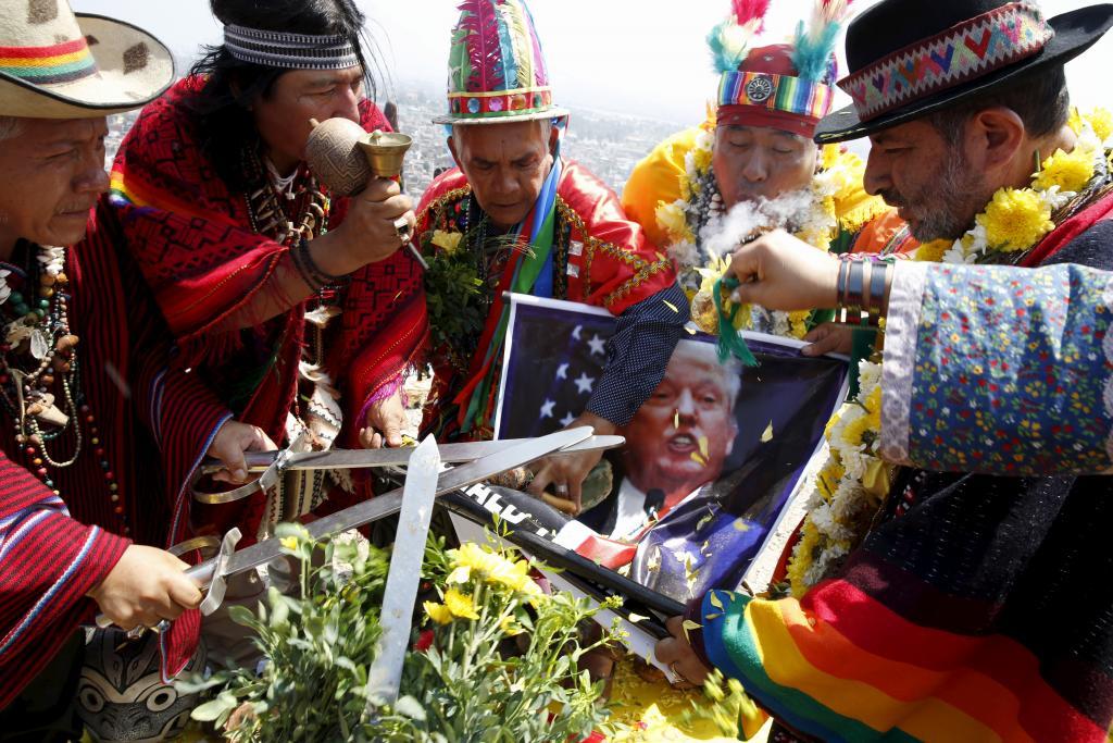 Peruvian shamans holding a poster of US Republican presidential candidate Donald Trump perform a ritual of predictions for the new year at Morro Solar hill in Chorrillos, Lima, Peru, Dec. 29, 2015. The ritual is an end-of-the-year tradition and the shaman