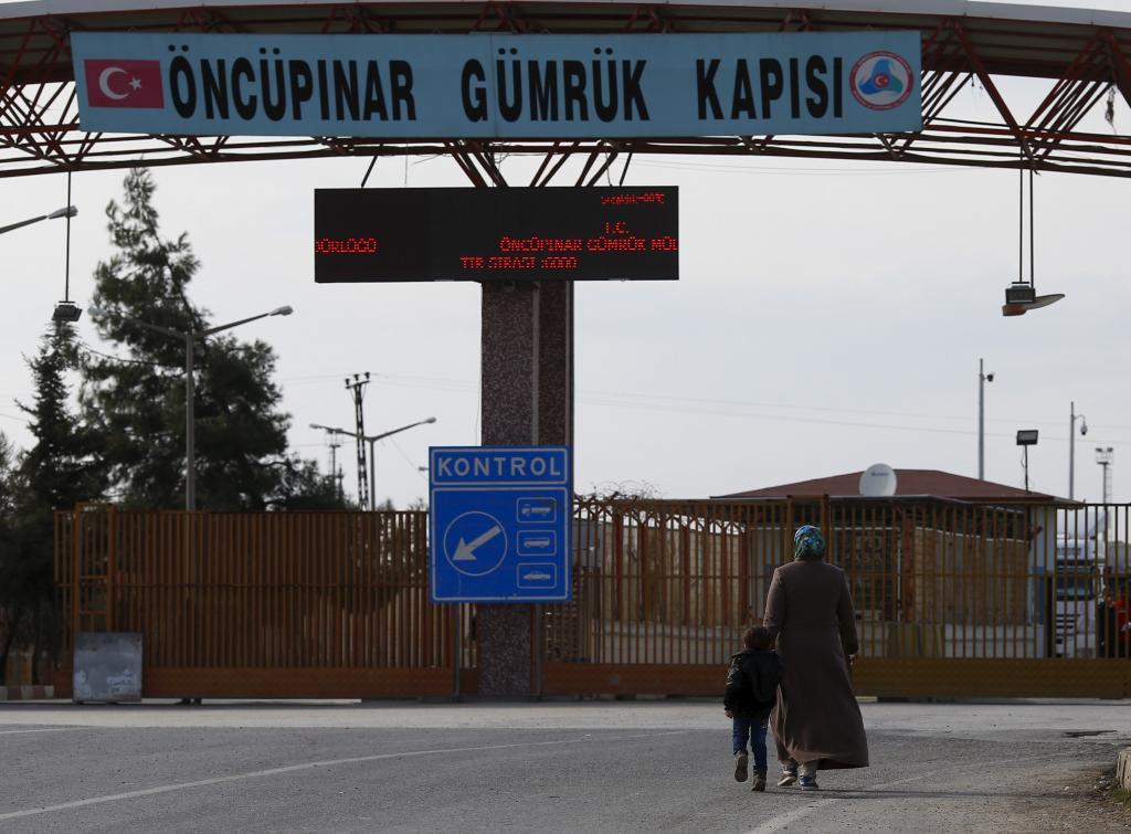 Syrians walk at the Oncupinar crossing on the border with Syria in the southeastern city of Kilis, Turkey on Feb. 10.