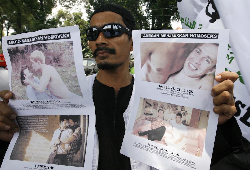 A member of the Islamic Defenders Front (FPI) protests against an LGBT film festival in Jakarta, September 28, 2010. His posters read: "Disgusting Gay Scene."