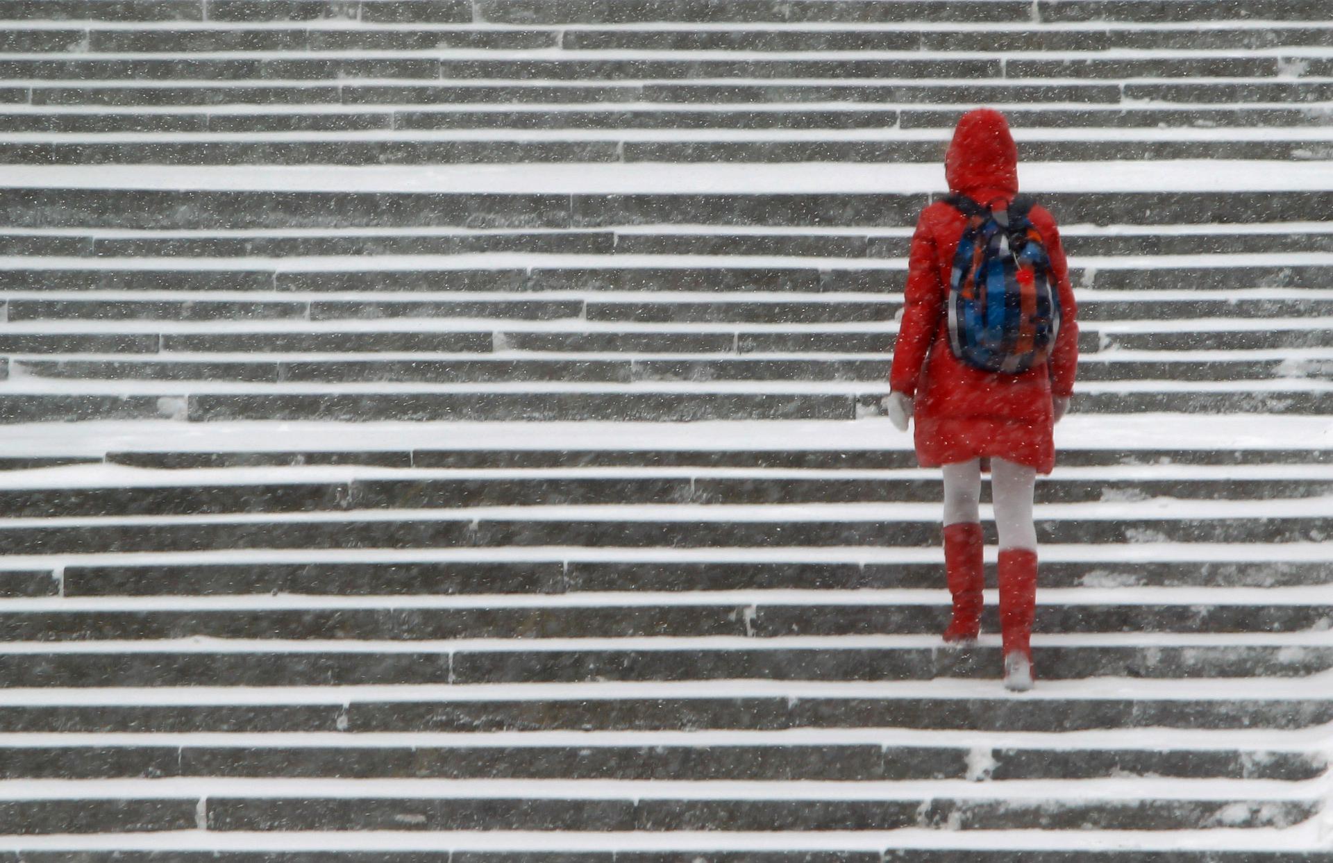 A woman walks in the snow in Moscow December 26, 2011.