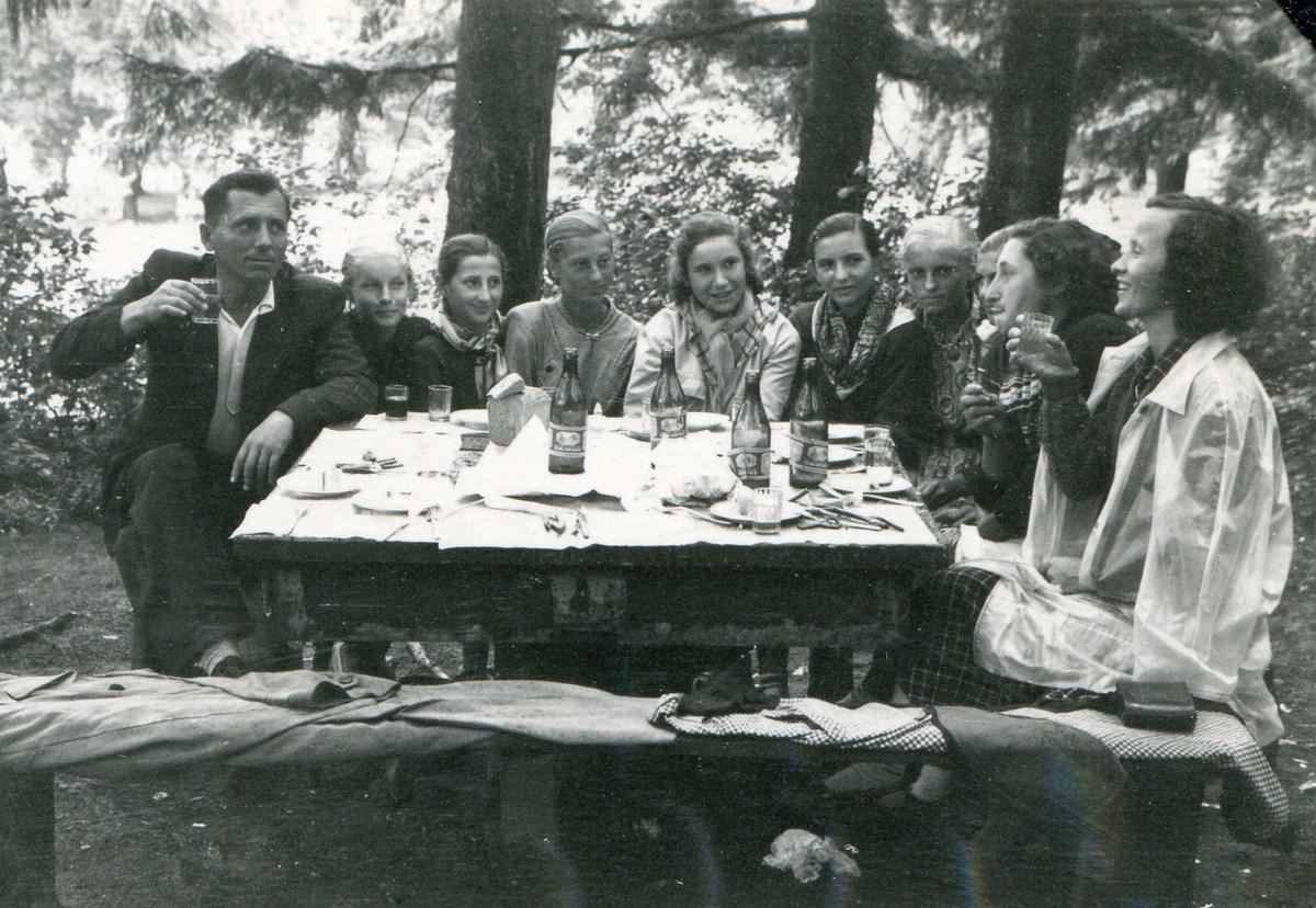Ukrainians Yuriy and Varvara Balega at a picnic table, with some of Varvara's students in between.