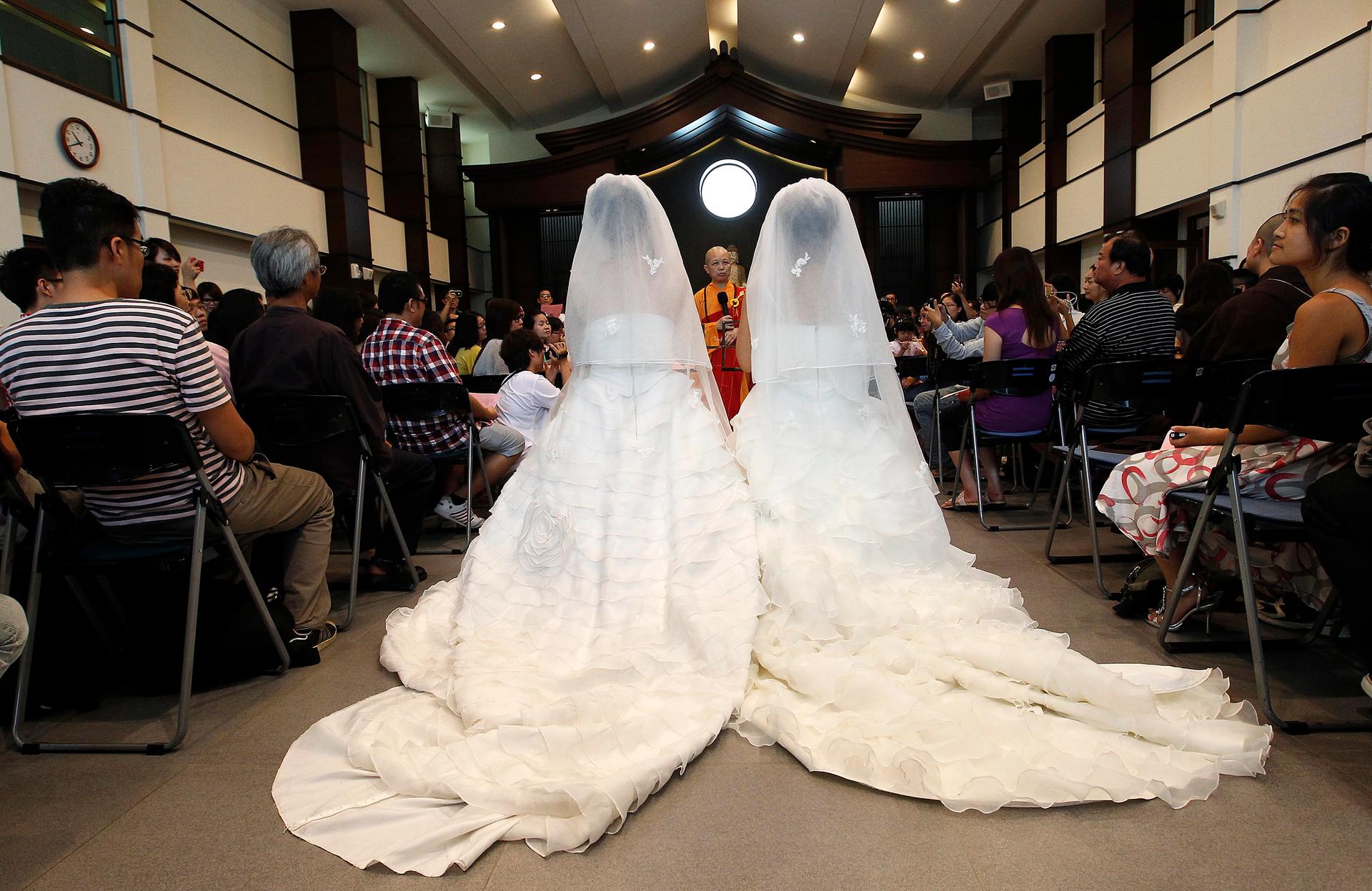 You Ya-ting and Huang Mei-yu take part in a symbolic same-sex Buddhist wedding ceremony at a temple in Taoyuan county, northern Taiwan, August 11, 2012.