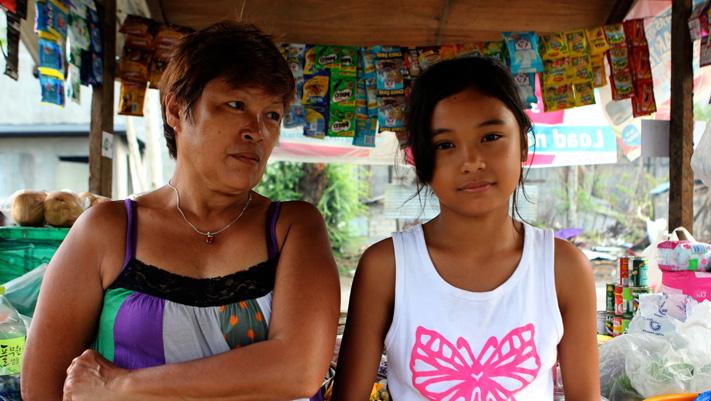 Delma Yerro, 53, and her granddaughter Heavenly at their sari-sari store in Tacloban, Philippines.