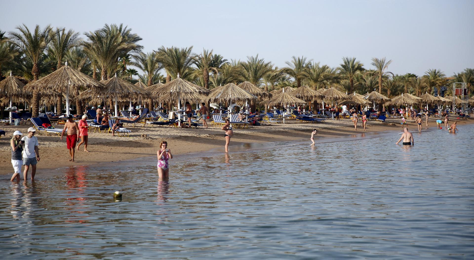 Tourists enjoy the beach at the Red Sea resort of Sharm el-Sheikh, Egypt