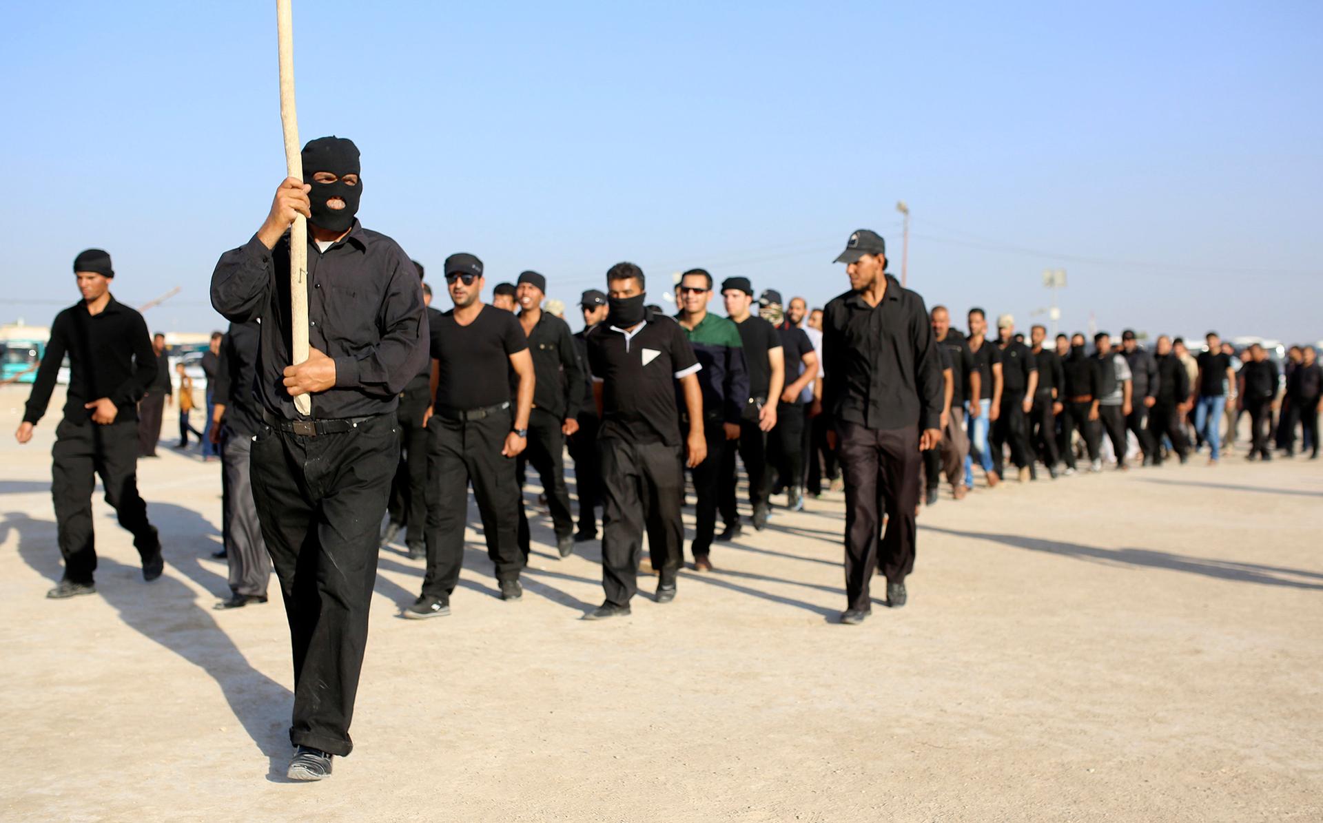 Mehdi Army fighters loyal to Shi'ite cleric Moqtada al-Sadr march during a military-style training in the holy city of Najaf, June 16, 2014. 